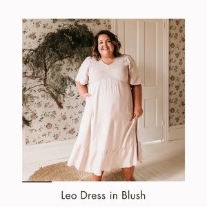 Blush floor length dress with flutter sleeves.